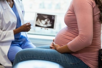 a pregnant woman gets an ultrasound and speaks to a doctor
